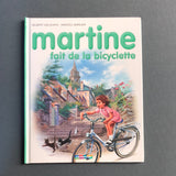 Martine va in bicicletta